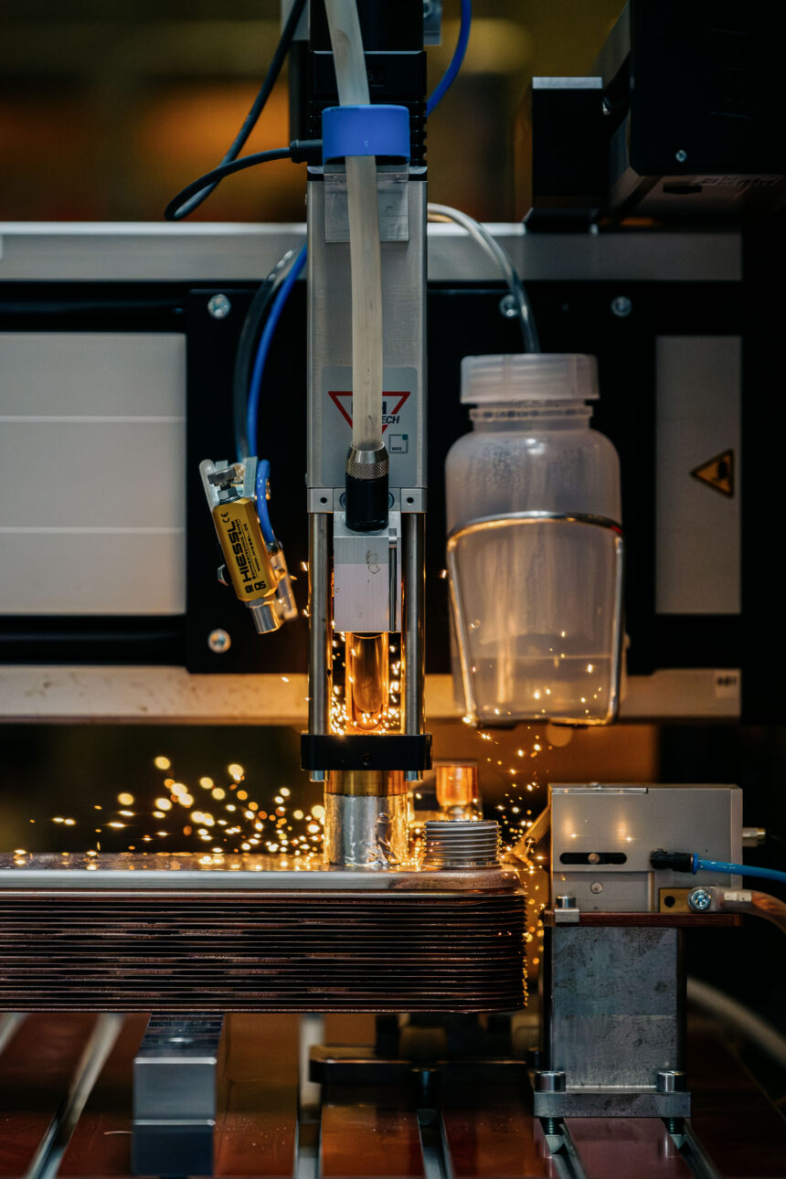 Automated welding on a Kelvion plate heat exchanger production line, sparks flying from the weld seam